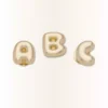 Talismane Jibbitz™ cu litera „a” aurie în formă de bulă Talismane Jibbitz™ cu litera „a” aurie în formă de bulă
